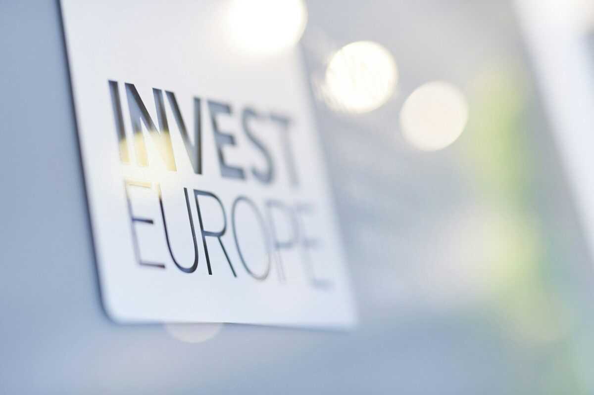A sign displaying 'invest europe' with a blurred background.