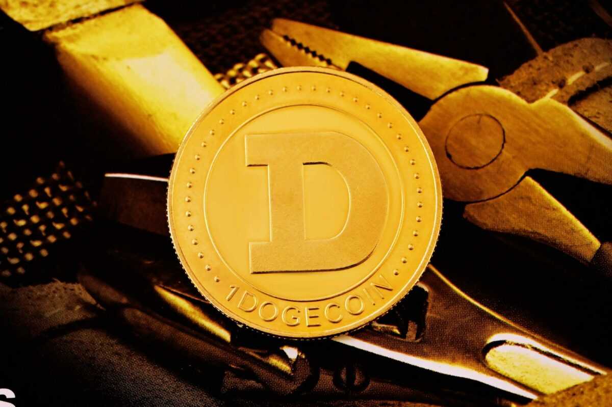 a close up of a gold coin with scissors in the background
