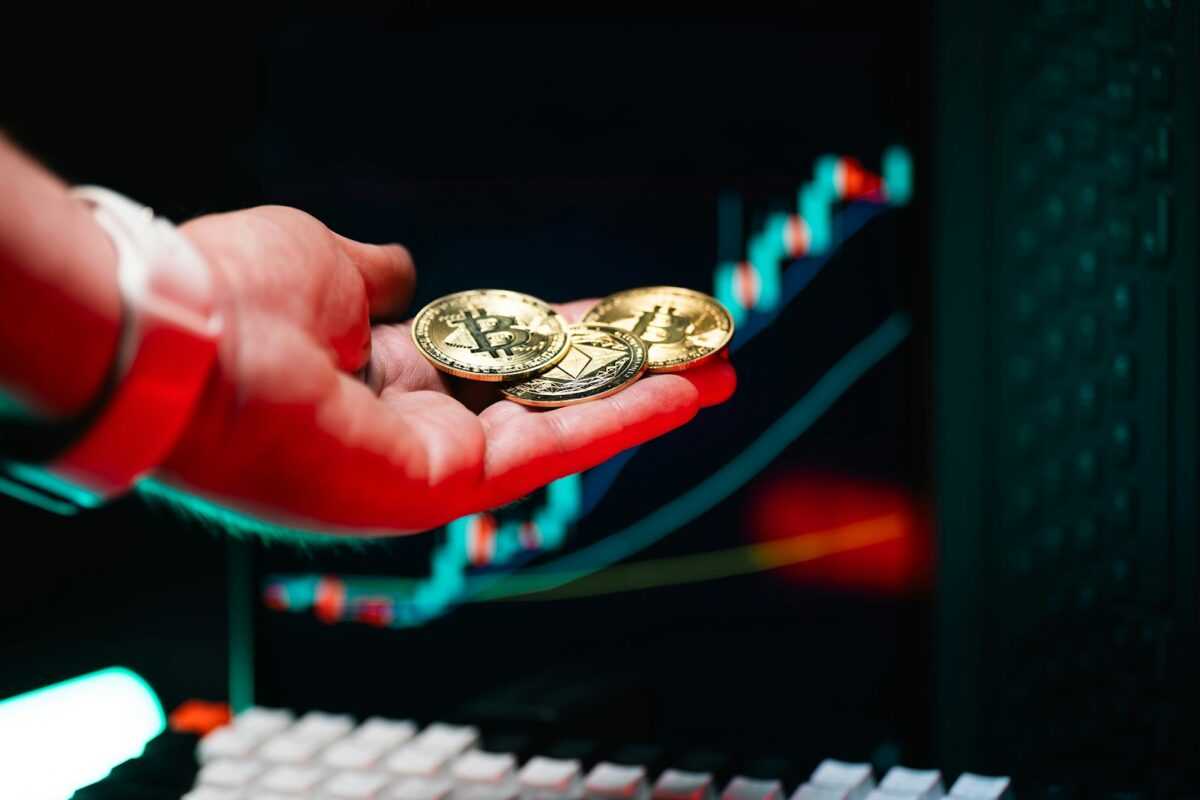 A person holding two gold coins in their hand