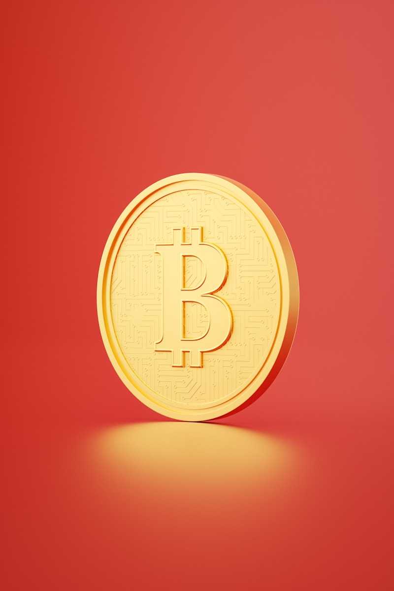 a gold bit coin on a red background